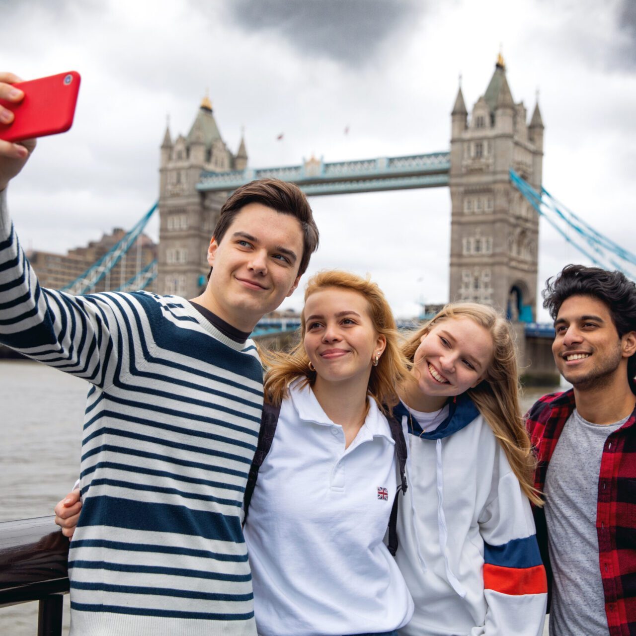 Teenage friends visiting London on Tower Bridge